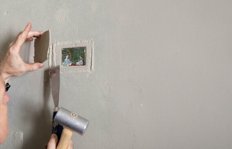 Johannes Rauchenberger öffnet in der Ausstellung „NUN MEHR – MEANTIME (2025)“ die Lehmabdeckungen von Maaria Wirkkalas „SHARING – Permanent Collection“, die die finnische Künstlerin 2011 in den damals neuen Lehmwänden „freigelegt“ hat.